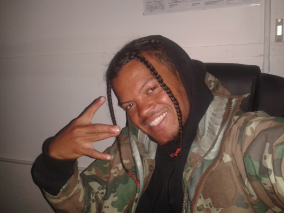 Epic.G smiling in camouflage jacket
